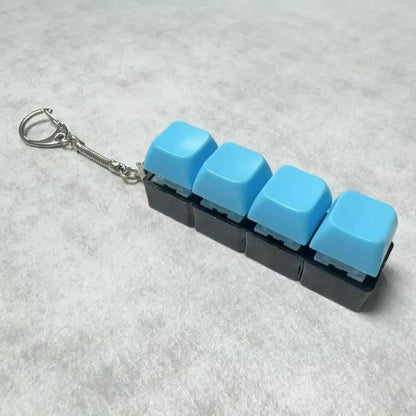 Ny Stress Ångest Lindring Tangentbord Nyckelring Fyrfingerknapp för Kontor Hem Vuxna Barn Dekompression Klicker Heta Gadget Presenter