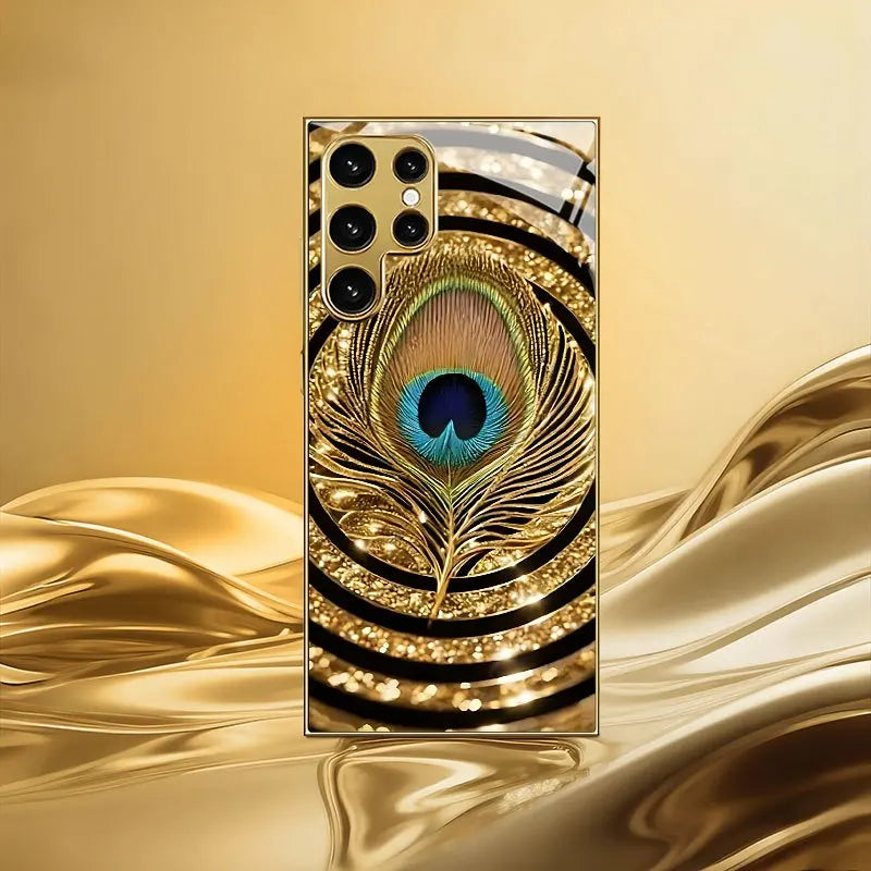 Mobilskal i härdat glas med guldplätering, kompatibelt med Galaxy S26, S25, S24, S23 och S22 Ultra Plus. Med ett mönster av guld- och blå fjädrar